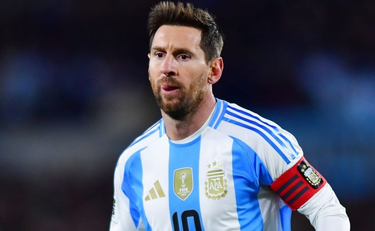 Argentine soccer player in blue-and-white striped jersey with red captain’s armband on his sleeve